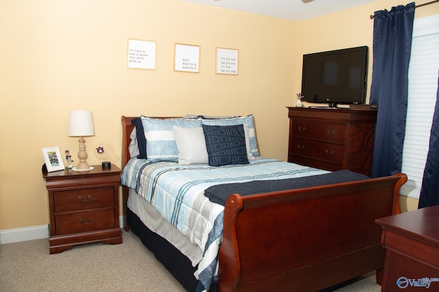 carpeted bedroom featuring baseboards