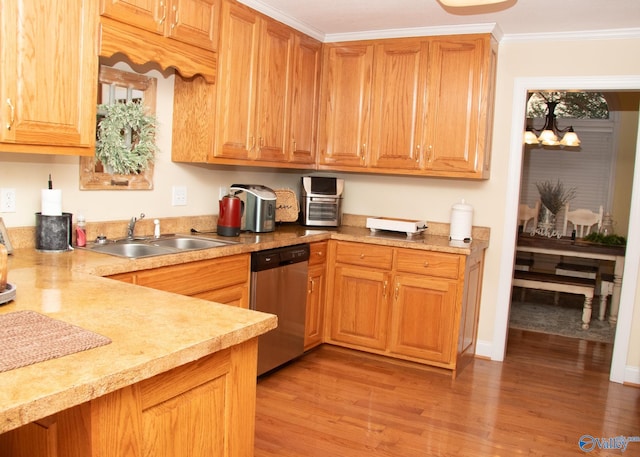 kitchen featuring a sink, light countertops, light wood-type flooring, and dishwasher