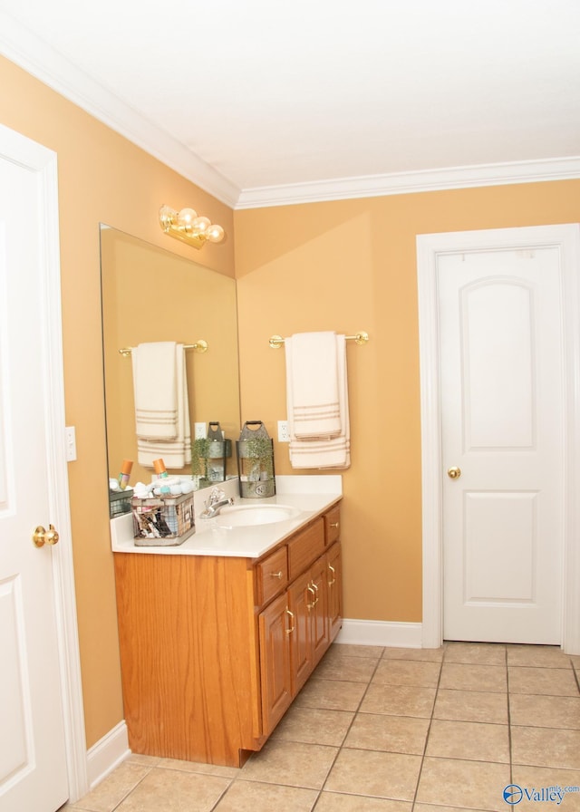 bathroom with ornamental molding, baseboards, tile patterned flooring, and vanity