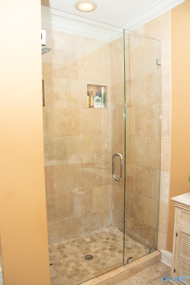 bathroom featuring a shower stall, vanity, and crown molding