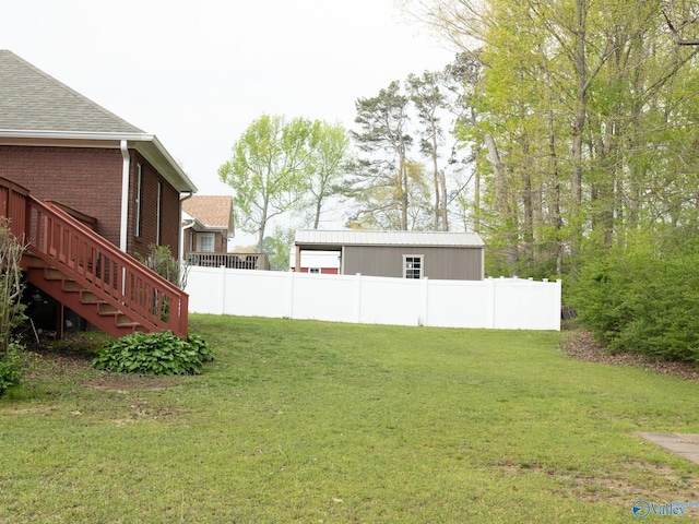 view of yard with fence and stairway