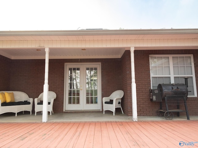 deck with french doors and a grill