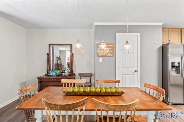 dining space with baseboards, wood finished floors, a textured ceiling, and ornamental molding
