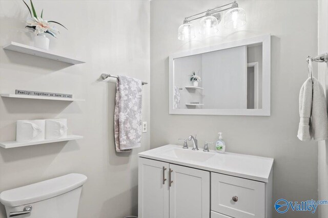bathroom featuring toilet and vanity
