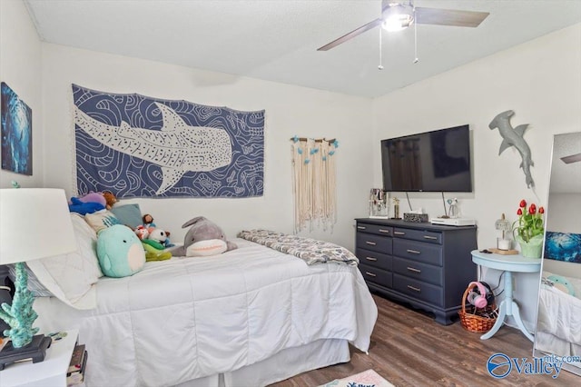 bedroom with ceiling fan and dark wood-style flooring