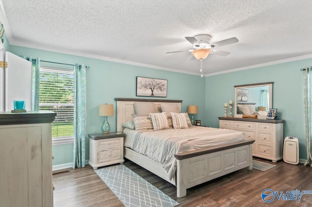 bedroom featuring a textured ceiling, visible vents, ornamental molding, and dark wood-style flooring