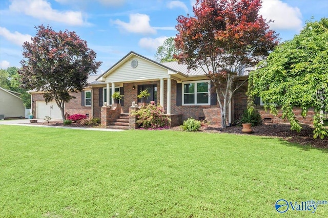 view of front of house featuring a porch, a front yard, an attached garage, and brick siding
