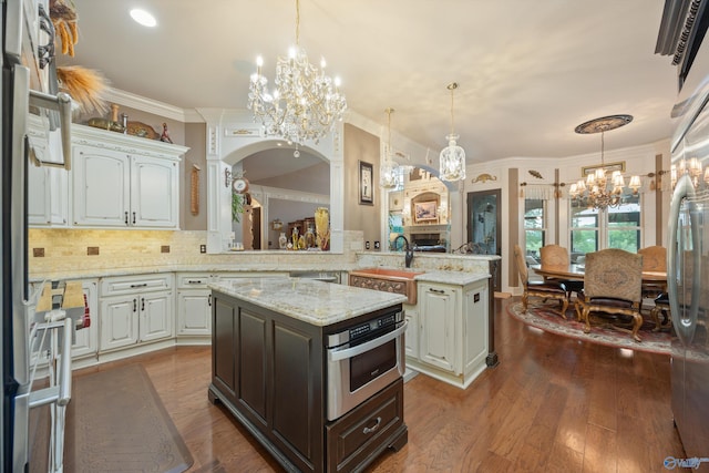 3 Mcmullen Ln, Gurley, AL 35748 - kitchen with a chandelier, a sink, decorative light fixtures, crown molding, and tasteful backsplash