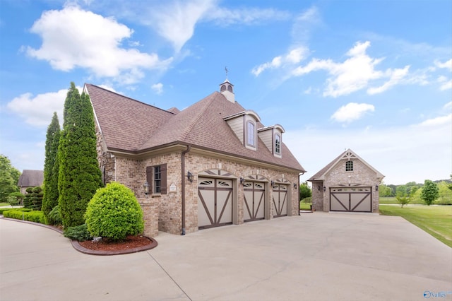 3 Mcmullen Ln, Gurley, AL 35748 - view of side of property with brick siding, driveway, roof with shingles, a chimney, and an attached garage