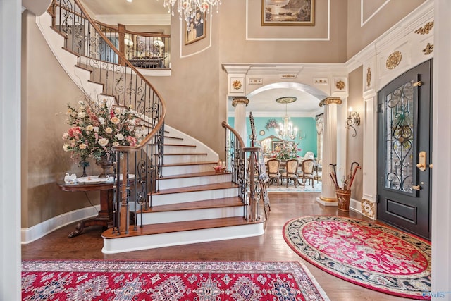 3 Mcmullen Ln, Gurley, AL 35748 - entryway featuring a chandelier, a high ceiling, decorative columns, ornamental molding, and wood finished floors