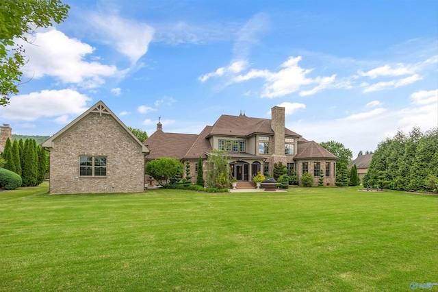 3 Mcmullen Ln, Gurley, AL 35748 - back of house featuring a yard, brick siding, a chimney, and a patio area