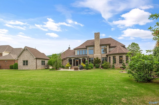 3 Mcmullen Ln, Gurley, AL 35748 - back of house featuring a chimney, a yard, a patio area, and brick siding