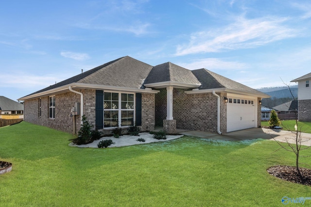 view of front of house featuring a garage, brick siding, driveway, and a front lawn