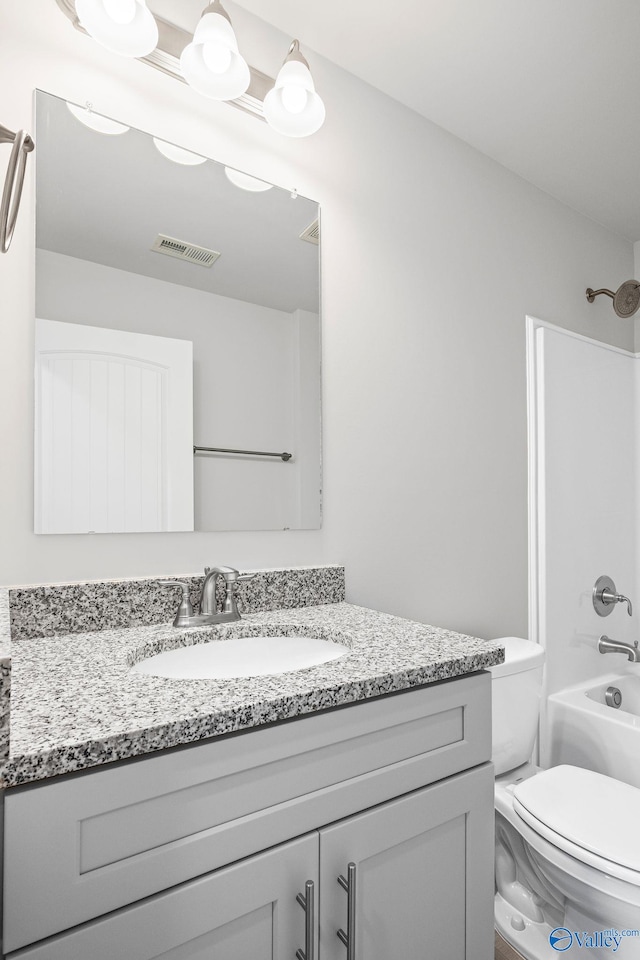 bathroom featuring toilet, visible vents, shower / washtub combination, and vanity