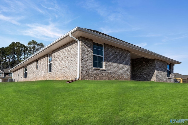 view of property exterior featuring a yard and central AC unit