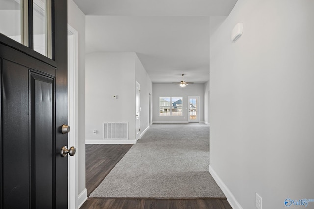 entryway featuring dark wood-style floors, visible vents, baseboards, and a ceiling fan