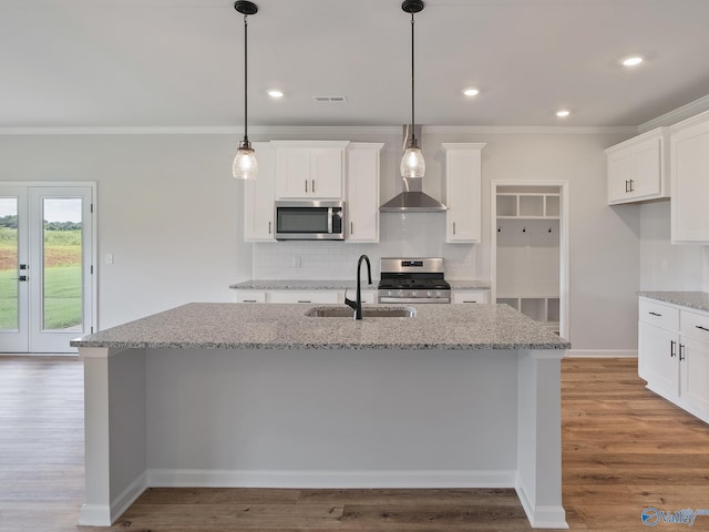 183 Saddle St, New Market, AL 35761 - kitchen with backsplash, wood finished floors, a sink, and stainless steel appliances