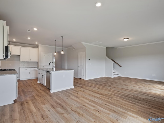 183 Saddle St, New Market, AL 35761 - kitchen with backsplash, a sink, light wood finished floors, open floor plan, and stainless steel appliances