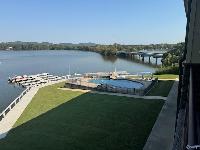 view of dock featuring a water view and a lawn