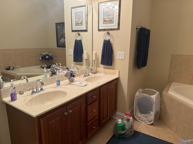 bathroom featuring vanity, tiled bath, and tile patterned flooring