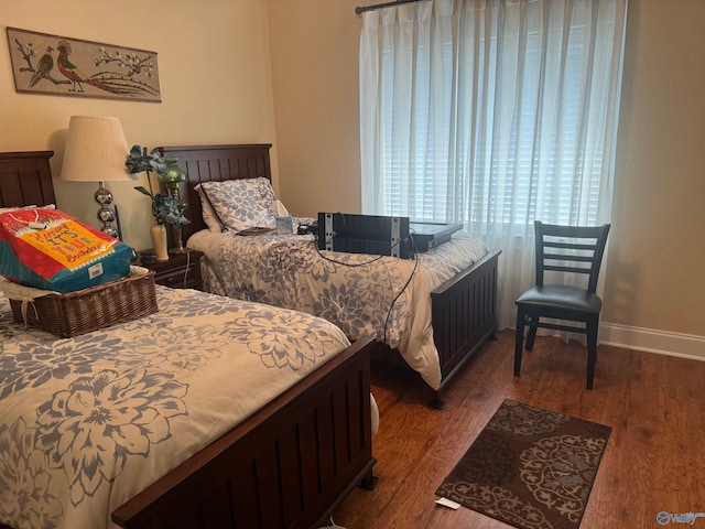 bedroom with dark hardwood / wood-style flooring