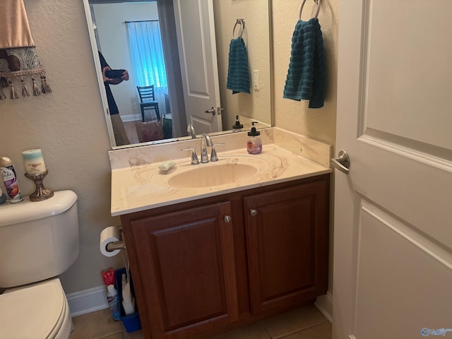 bathroom with vanity, tile patterned flooring, and toilet