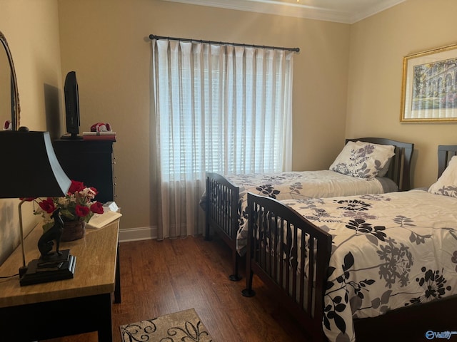 bedroom featuring crown molding and dark wood-type flooring