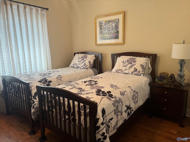 bedroom with dark wood-type flooring