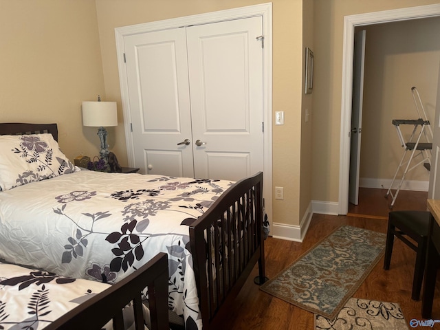 bedroom with dark wood-type flooring and a closet