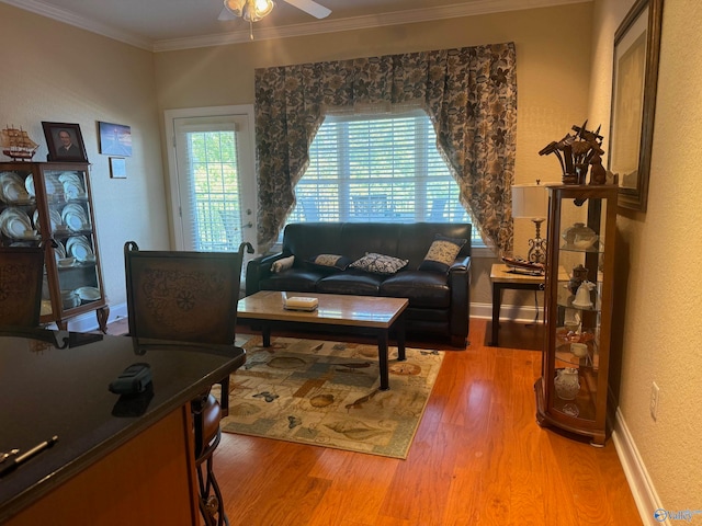 living room featuring ornamental molding, hardwood / wood-style floors, and ceiling fan