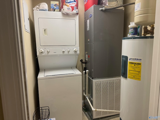 washroom featuring electric water heater and stacked washer / dryer