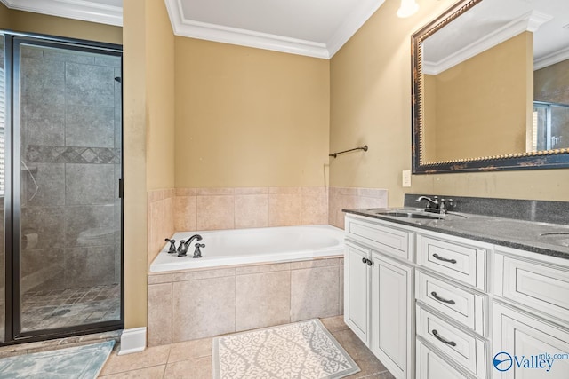 bathroom with a sink, crown molding, a stall shower, and a garden tub