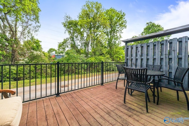 wooden terrace with outdoor dining space