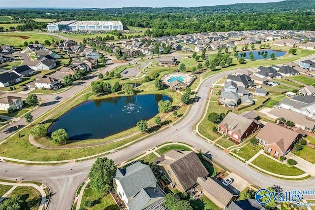 birds eye view of property with a water view and a residential view