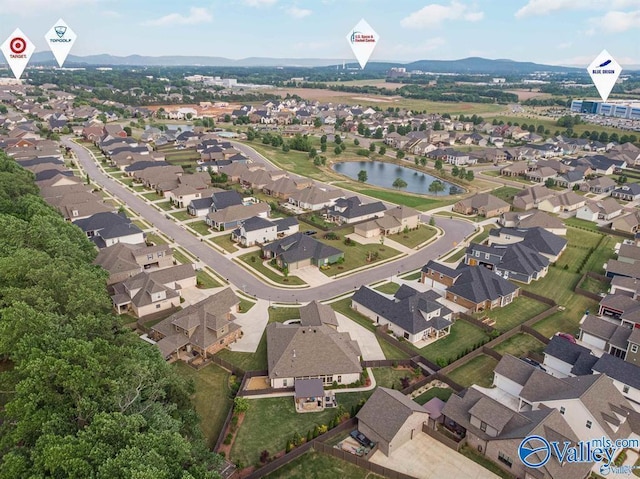 drone / aerial view with a residential view and a water and mountain view
