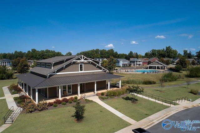 exterior space featuring a porch, a yard, and fence