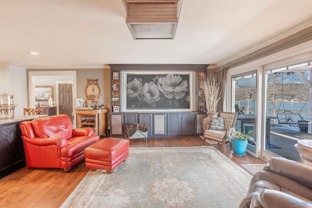 living room with crown molding and hardwood / wood-style floors