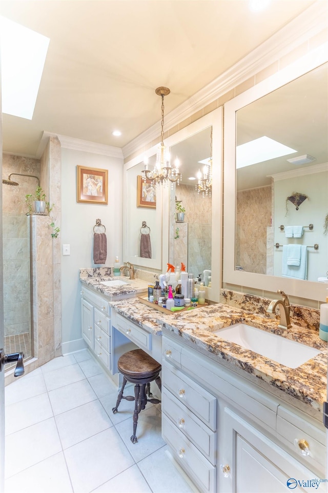 bathroom with a skylight, tile patterned flooring, ornamental molding, vanity, and a shower with door