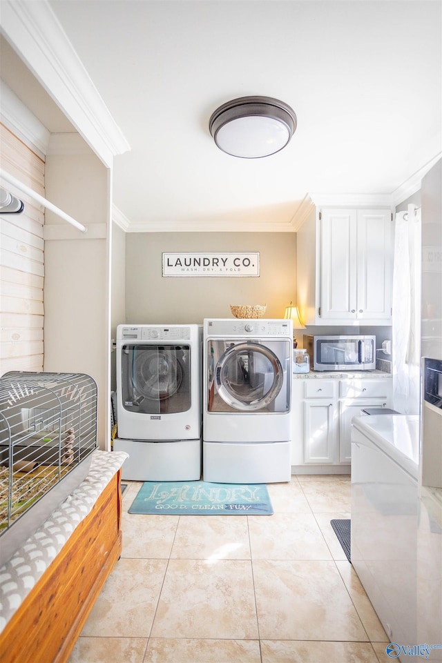 clothes washing area with light tile patterned floors, ornamental molding, and independent washer and dryer