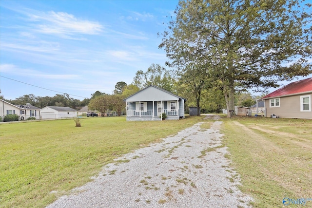 bungalow-style home with a front lawn and a porch