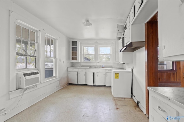 kitchen featuring stove, plenty of natural light, white cabinets, and sink