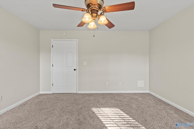 carpeted spare room featuring ceiling fan