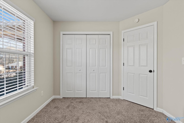 unfurnished bedroom with carpet flooring and a closet