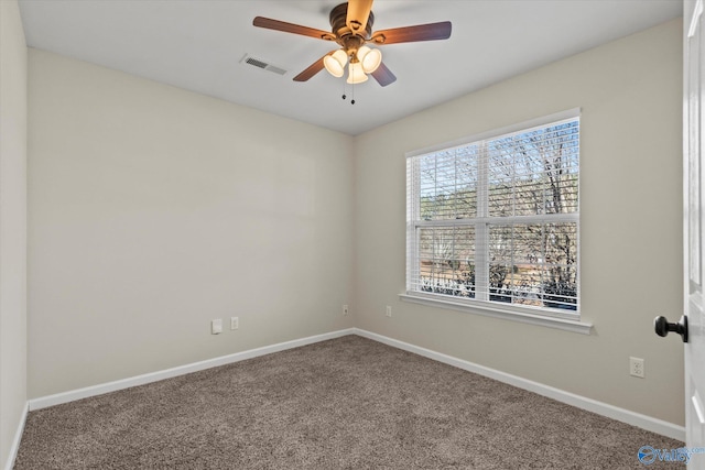 empty room featuring carpet floors and ceiling fan