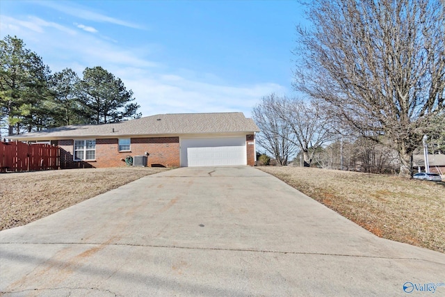 view of side of home featuring a garage, a yard, and central AC unit