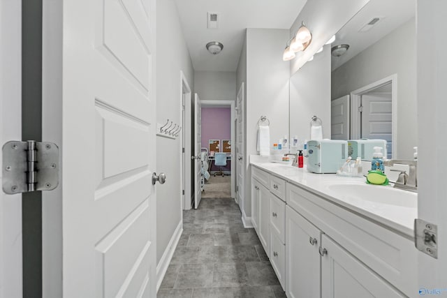 7531 Hadleigh Crst, Owens Cross Roads, AL 35763 - bathroom with double vanity, ensuite bathroom, and baseboards