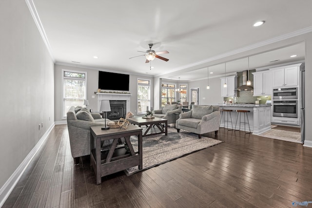 7531 Hadleigh Crst, Owens Cross Roads, AL 35763 - living room with crown molding, ceiling fan, a fireplace, baseboards, and dark wood finished floors
