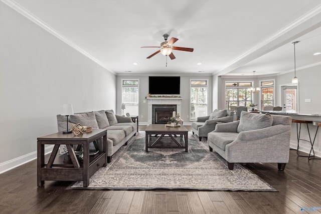 7531 Hadleigh Crst, Owens Cross Roads, AL 35763 - living room with a ceiling fan, baseboards, ornamental molding, dark wood-style flooring, and a glass covered fireplace