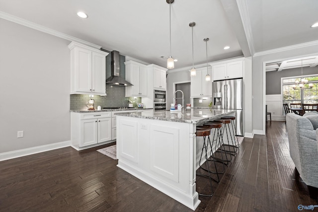7531 Hadleigh Crst, Owens Cross Roads, AL 35763 - kitchen featuring wall chimney exhaust hood, appliances with stainless steel finishes, tasteful backsplash, white cabinets, and a breakfast bar area
