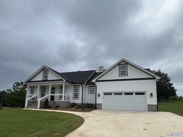 2385 Cedar Ridge Cir, Hokes Bluff, AL 35903 - view of front of home with concrete driveway, a front lawn, an attached garage, and a porch